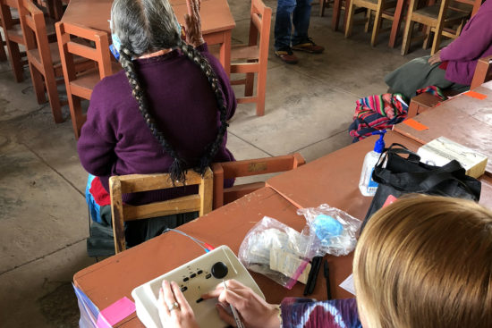 Bailey Neuhaus conducting a hearing evaluation on a patient in Peru